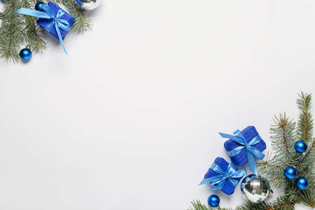 Composition with Christmas gift boxes, fir branches and balls on light backgroundの写真素材