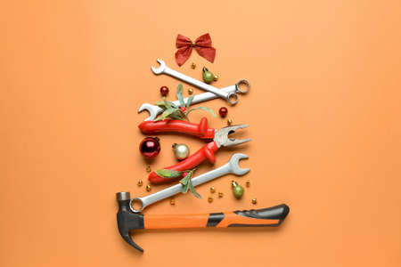 Christmas tree made of construction tools on color backgroundの写真素材