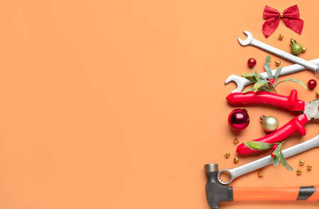 Christmas tree made of construction tools on color backgroundの写真素材