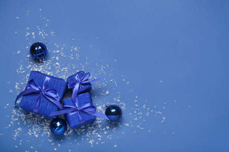 Composition with Christmas gift boxes and balls on blue background