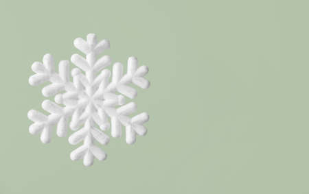 Beautiful snowflake on green backgroundの写真素材