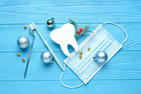 Dentist's supplies and Christmas decor on color wooden backgroundの写真素材