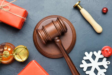 Judge's gavel, gifts and Christmas decor on dark backgroundの写真素材