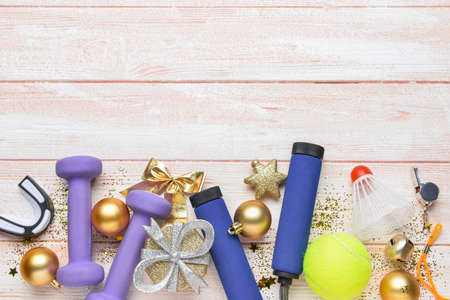 Sports equipment and Christmas decor on light wooden backgroundの写真素材