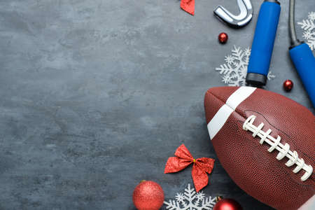 Rugby ball, jumping rope and Christmas decor on dark backgroundの写真素材