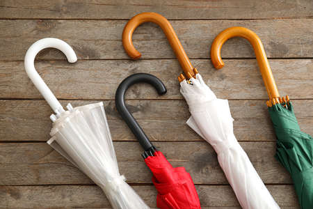 Different umbrellas on wooden background, closeupの写真素材