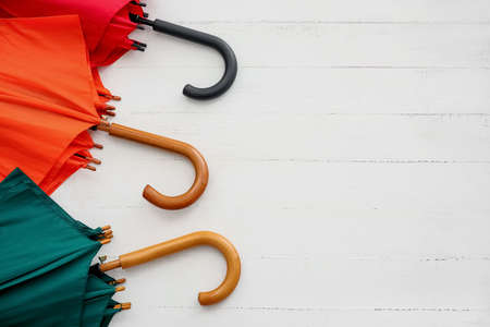 Bright umbrellas on light wooden background, closeupの写真素材