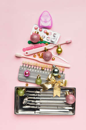 Christmas tree made of dentist's tools on color backgroundの写真素材