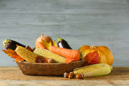 Basket with different healthy food on table. harvest festival