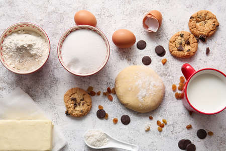 Fresh dough and ingredients for preparing homemade cookies on light backgroundの写真素材