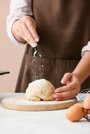 Woman preparing dough for homemade cookies at kitchen table, closeupの写真素材