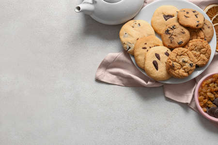 Plate of tasty homemade cookies with chocolate chips on white backgroundの写真素材
