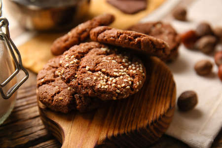 Board with tasty chocolate homemade cookies on table, closeupの写真素材