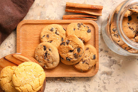 Wooden boards with tasty homemade cookies on beige background