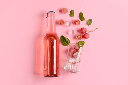 Composition with bottle of fresh soda on pink backgroundの写真素材
