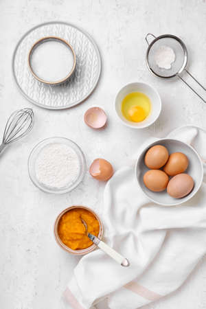 Fresh ingredients for preparing pumpkin pie on light backgroundの写真素材