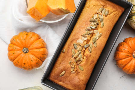 Baking dish with delicious pumpkin pie on white background, closeup