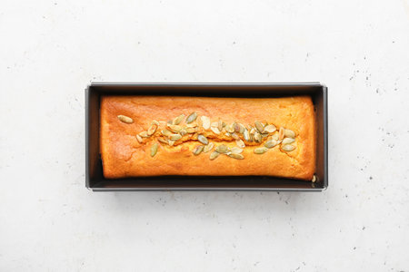 Baking dish with delicious pumpkin pie on white background