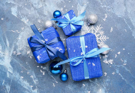 Beautiful Christmas gifts with decor on blue backgroundの写真素材