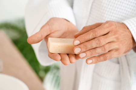 Young man with soap in bathroom, closeupの写真素材