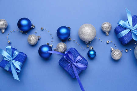 Beautiful Christmas gifts with decor on blue backgroundの写真素材