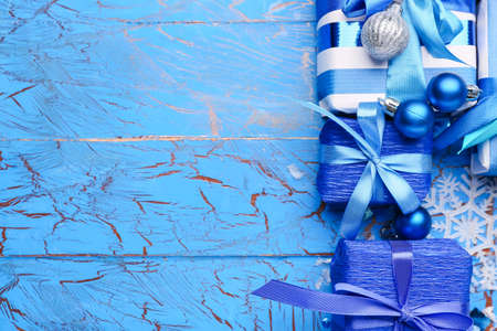Beautiful Christmas gifts with decor on blue wooden backgroundの写真素材