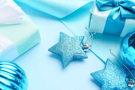 Beautiful Christmas decor with gifts on blue backgroundの写真素材