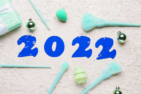 Figure 2022 with makeup supplies and snow on white backgroundの写真素材