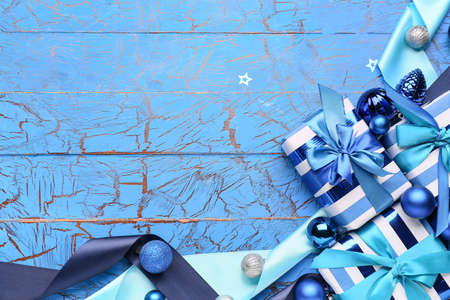 Beautiful Christmas gifts with decor on blue wooden backgroundの写真素材