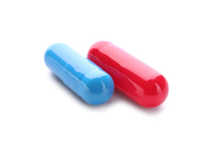 Blue and red pills on white background. concept of choiceの写真素材
