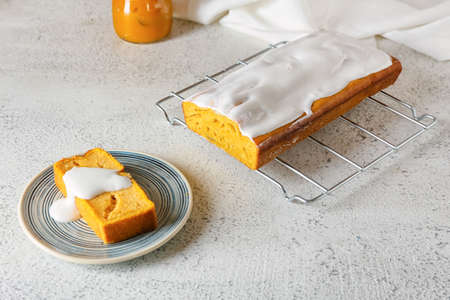Grid with cut pumpkin pie on light background