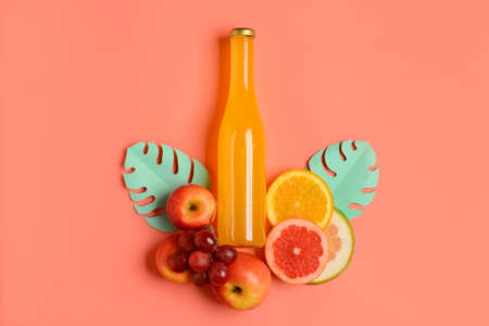 Composition with bottle of fresh soda and fruits on color backgroundの写真素材