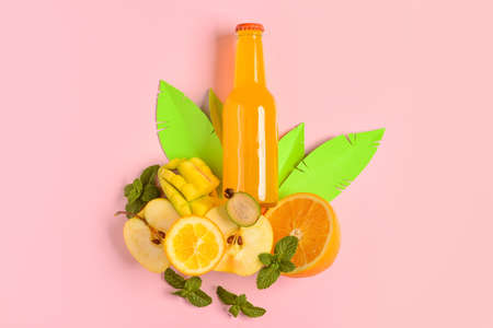 Composition with bottle of fresh soda, fruits and mint on pink backgroundの写真素材
