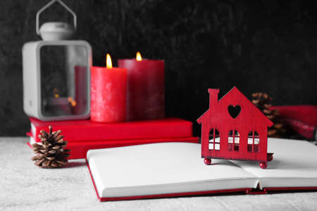 Book with glowing candle on table against dark background. christmas storyの写真素材