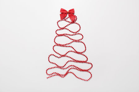Christmas tree made of decorations on light backgroundの写真素材