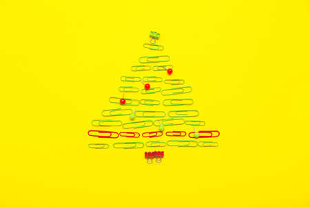 Christmas tree made of office supplies on color backgroundの写真素材