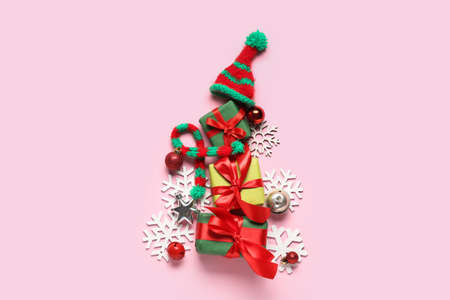 Christmas tree made of decorations and gifts on color backgroundの写真素材