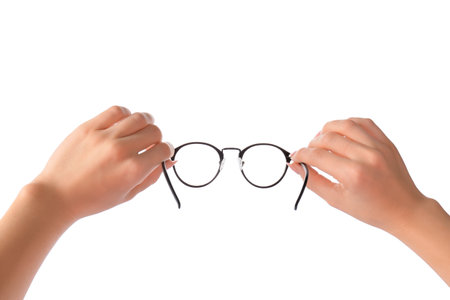 Female hands with new modern eyeglasses on white backgroundの写真素材