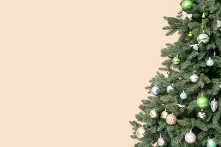 Beautiful Christmas tree with decor on beige background