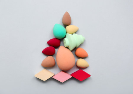 Christmas tree made of makeup sponges on gray backgroundの写真素材