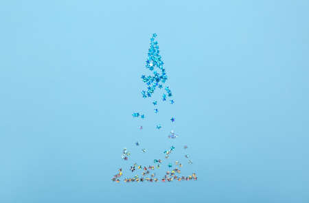 Christmas tree made of glitters on color background