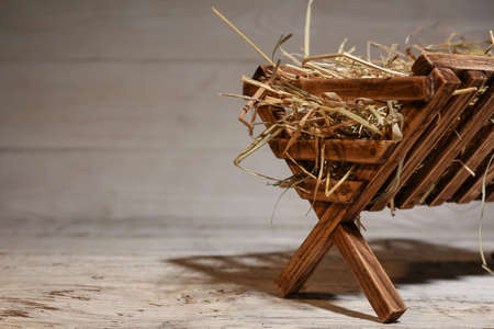 Manger with hay on light backgroundの写真素材