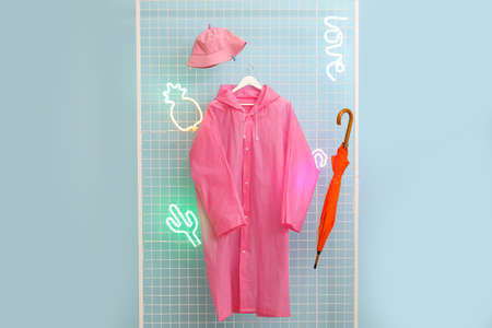 Raincoat, hat and umbrella in hallwayの写真素材