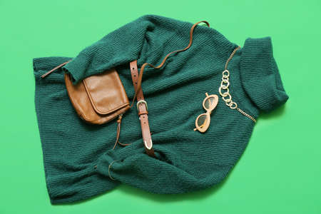Stylish female sweater and accessories on color backgroundの写真素材