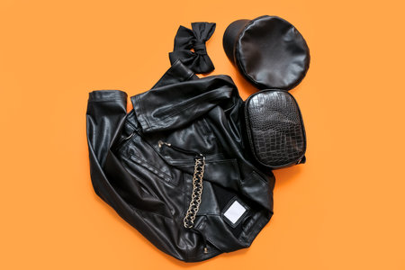Stylish leather jacket and female accessories on color backgroundの写真素材