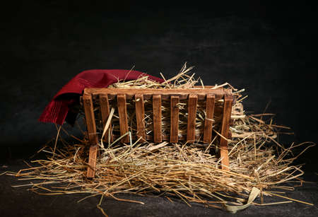 Manger with hay on dark backgroundの写真素材