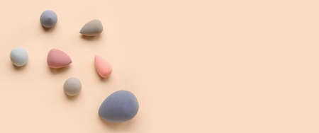 Different makeup sponges on beige background. Banner designの写真素材