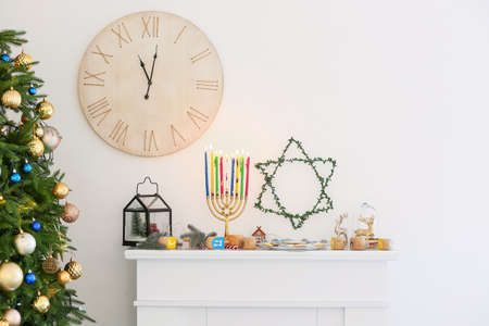 Beautiful decorations for Hanukkah celebration on fireplace in roomの写真素材