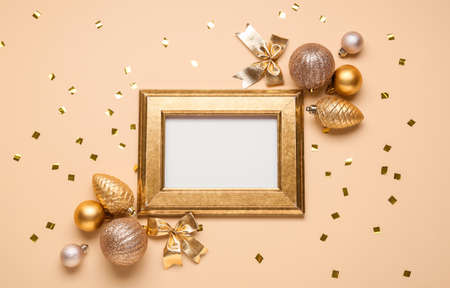 Blank photo frame, Christmas decor and confetti on color backgroundの写真素材