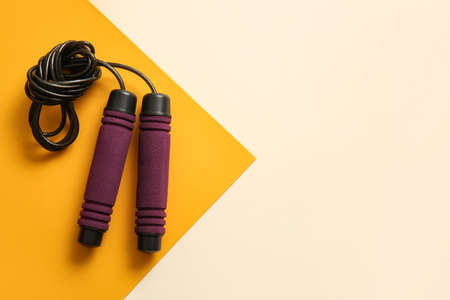 Stylish skipping rope on yellow backgroundの写真素材